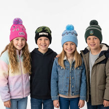 Load image into Gallery viewer, Four children standing together wearing colorful winter beanies and jackets against a plain light gray studio background. The hats feature different graphics and colors: pink with a pom-pom, black with 'FORTNITE' text, light blue with a blue pom-pom, and dark green with a gray stripe and pom-pom.
